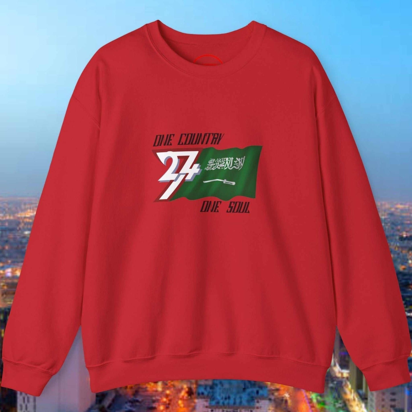 Red crewneck sweatshirt with hand-drawn Saudi Arabia flag and patriotic "One Country One Soul" design.