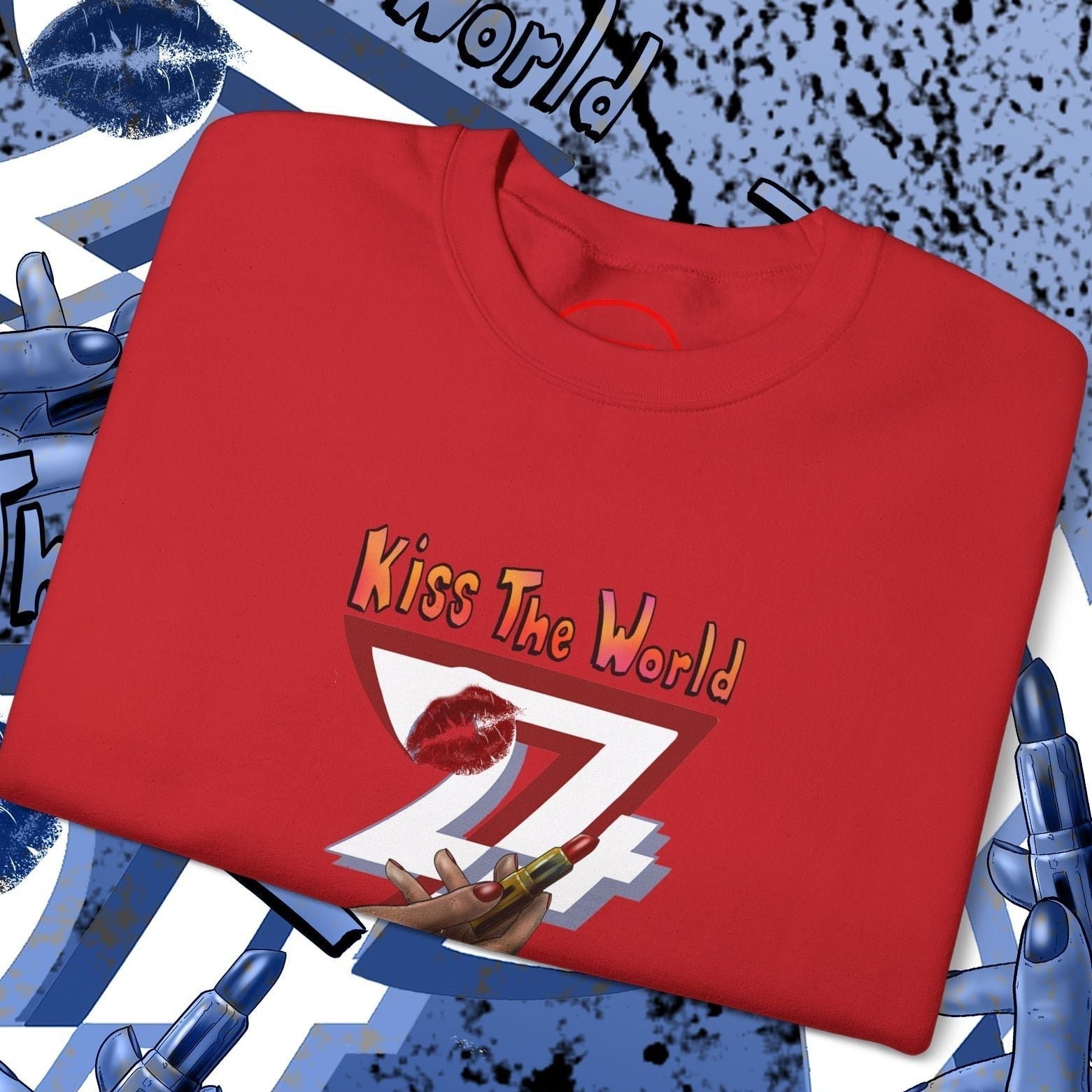 Red sweatshirt with lipstick design and "Kiss The World" text by 24/7 Unique Designs