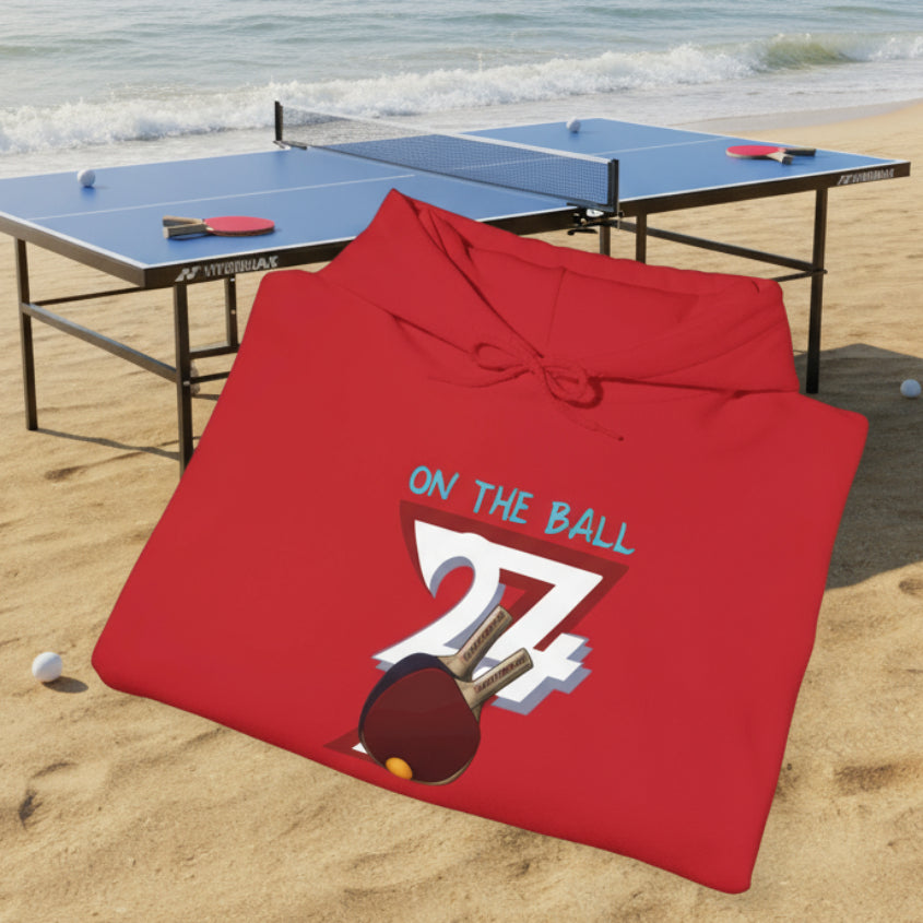 Red ping pong hoodie with hand-drawn design and "On The Ball" text, folded display