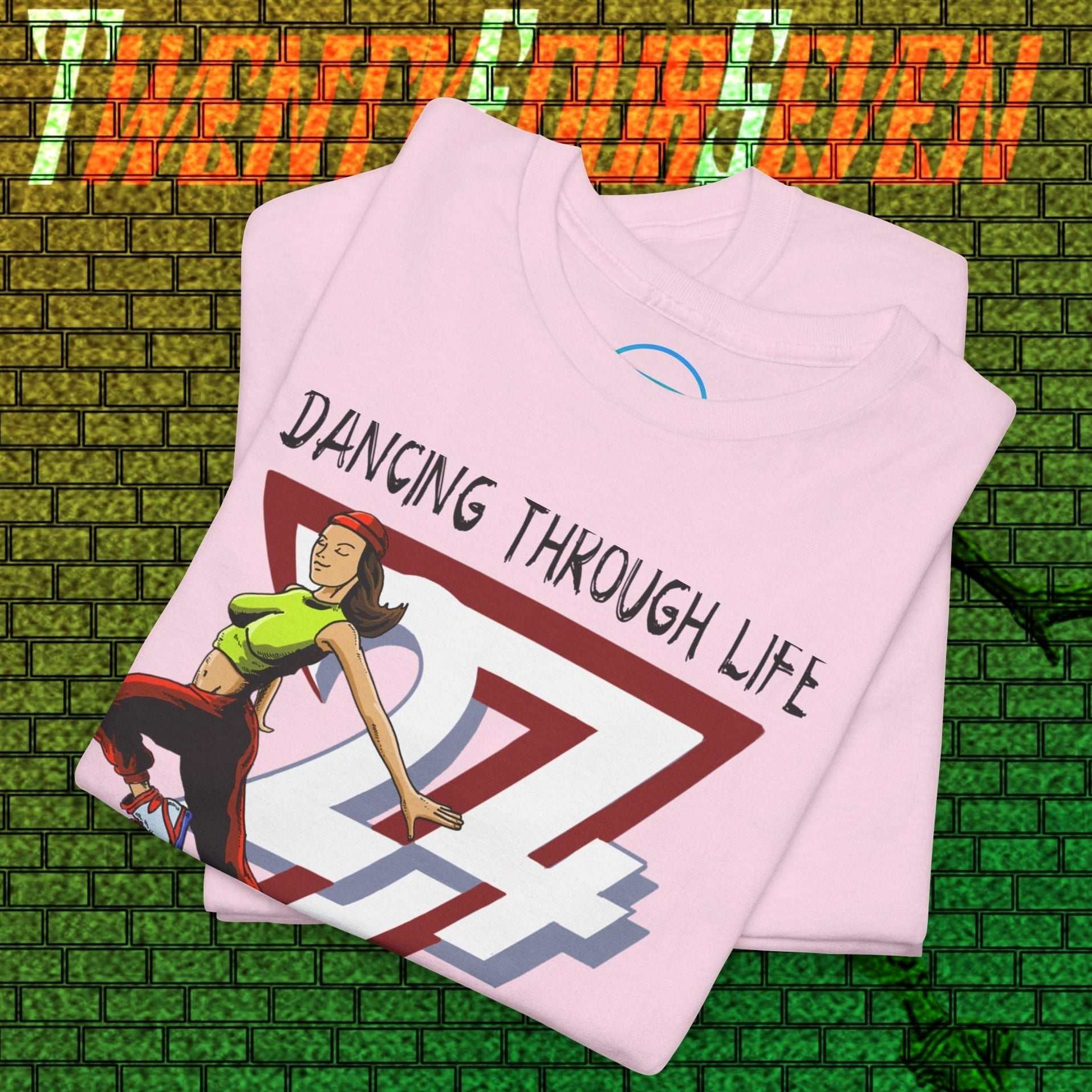 Street Dance Graphic Tee with vibrant hand-drawn urban dance illustration and "Dancing Through Life" text on soft pink fabric