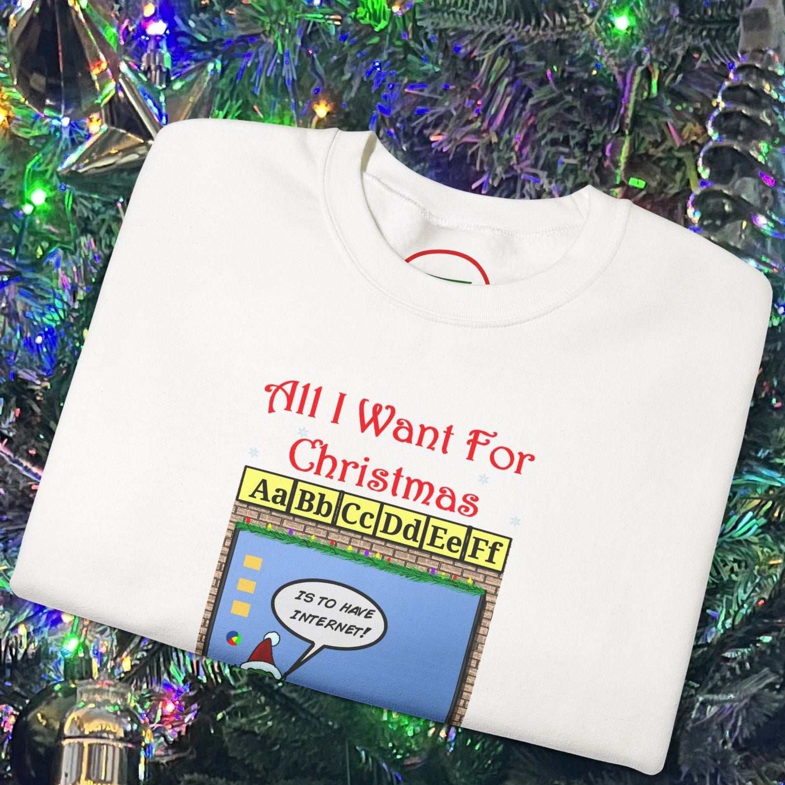 White Christmas Teachers and Elves Sweatshirt with colorful cartoon design and festive text on folded fabric by decorated Christmas tree