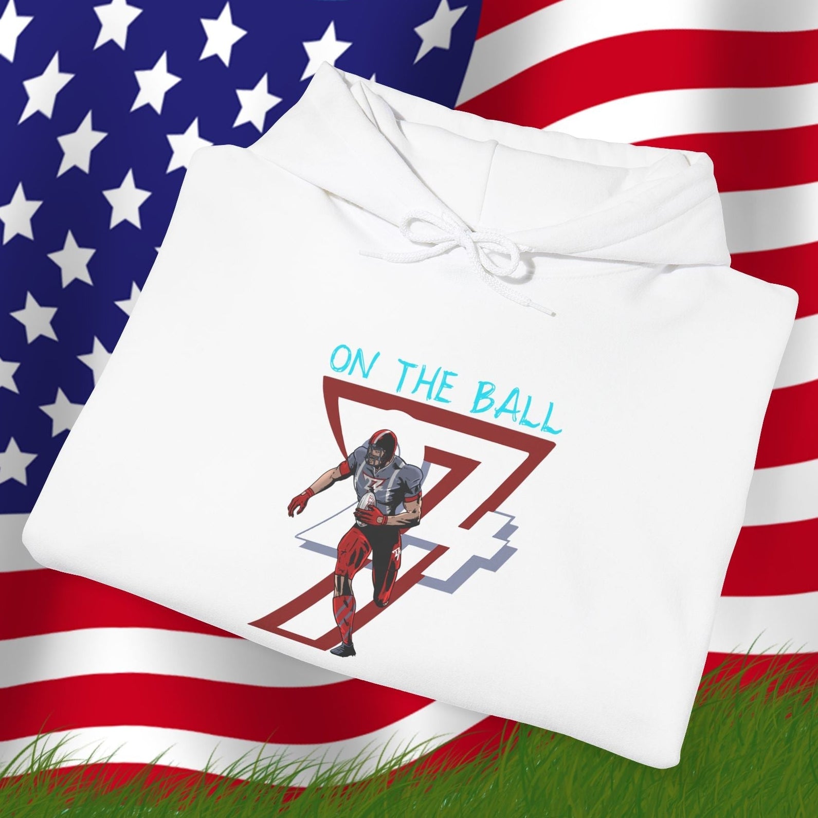 White american football hoodie with hand-drawn player design and "On The Ball" text, displayed on American flag background