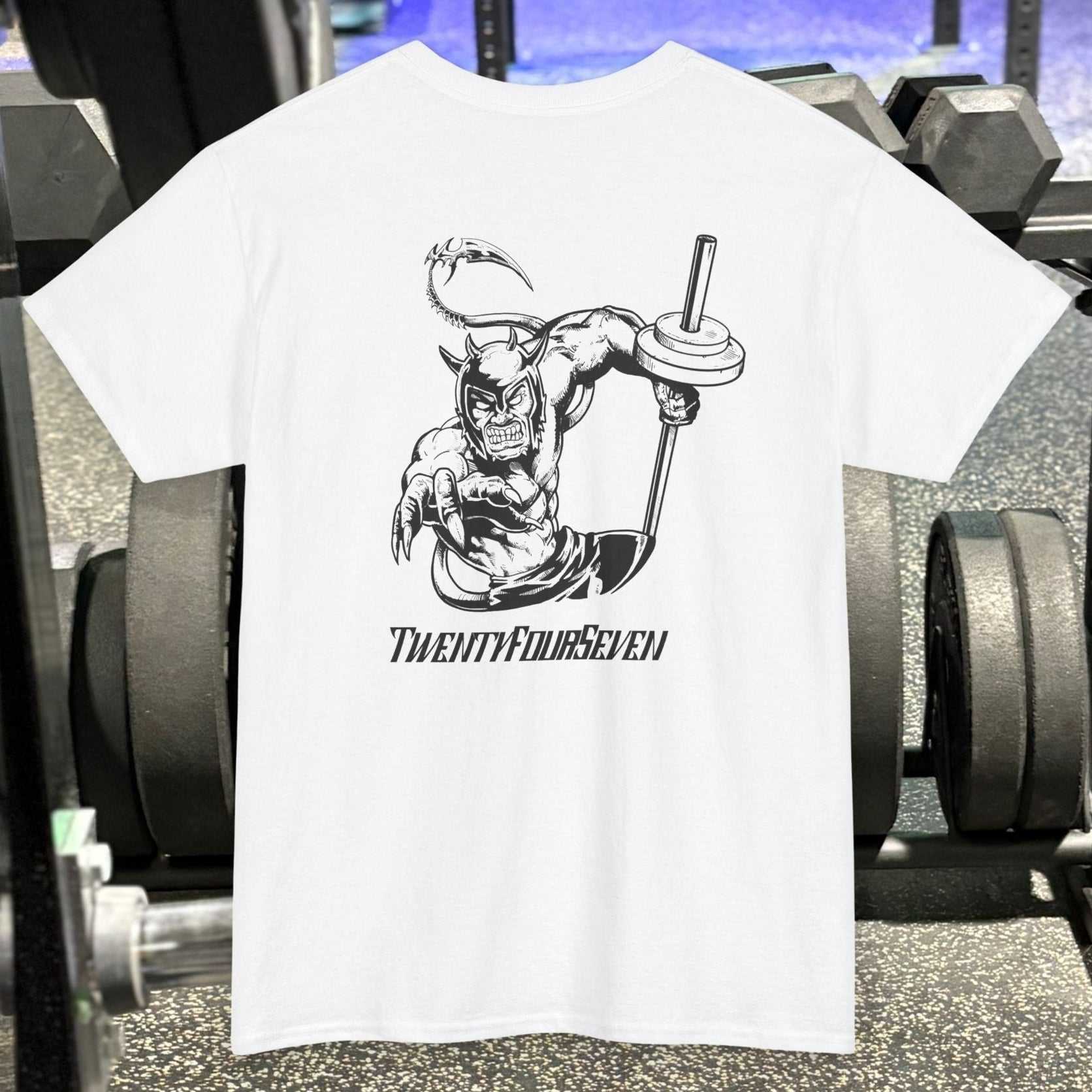 White bodybuilding tee with black comic-style muscular character holding a barbell and "TwentyFourSeven" text on gym background
