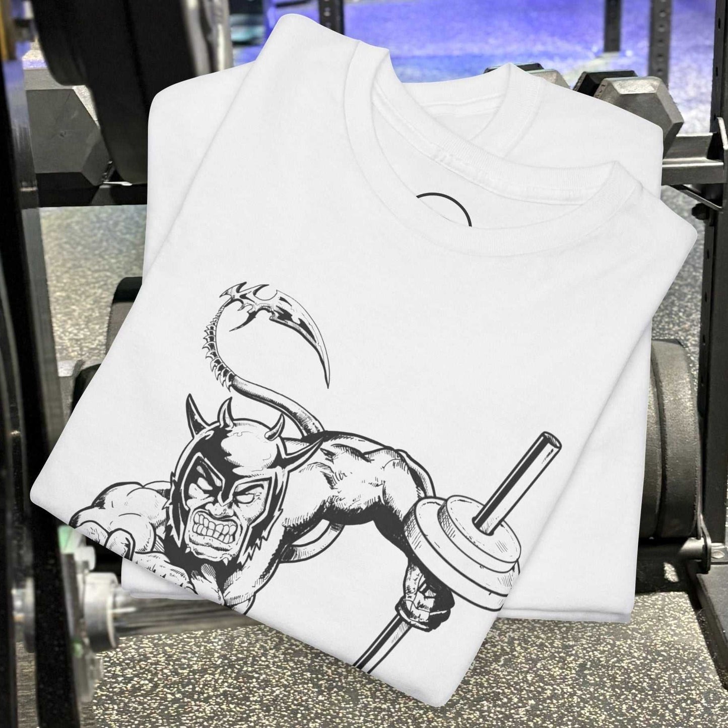 White comic-style gym tee with hand-drawn fantasy illustration of a muscular devil holding a barbell