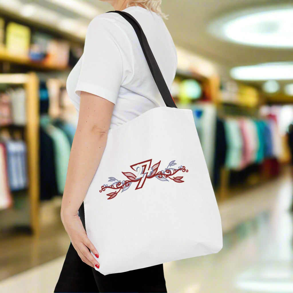 White floral design tote bag on woman's shoulder