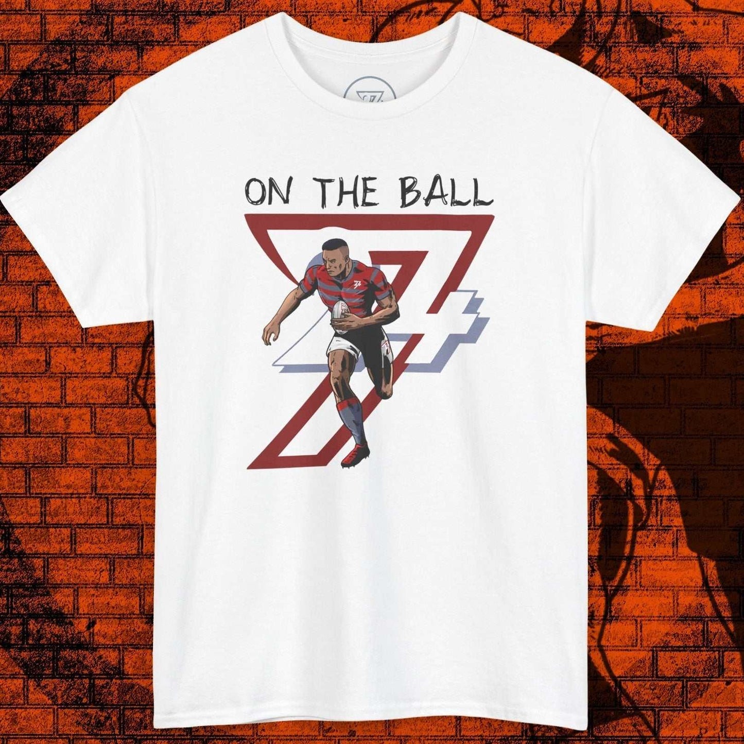 White rugby sports tee with hand-drawn rugby player illustration and "On The Ball" text, sporty graphic design
