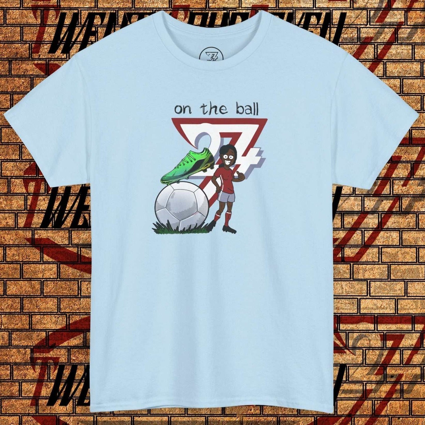 Women's light blue football boot tee with hand-drawn soccer graphic and "on the ball" text
