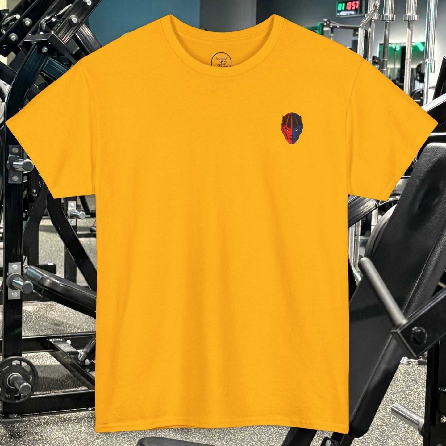 Yellow bodybuilding tee with small hand-drawn comic-style fitness character graphic on chest in gym setting