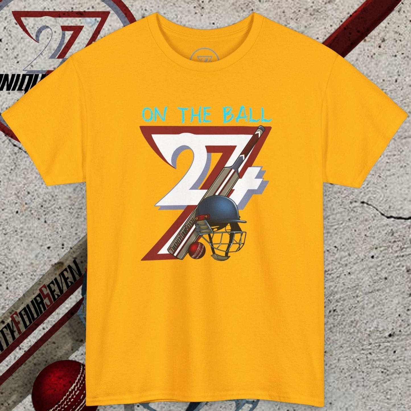 Yellow cricket tee with hand-drawn vintage 90s cricket design featuring a helmet, bat, ball, and "On the Ball 24/7" text