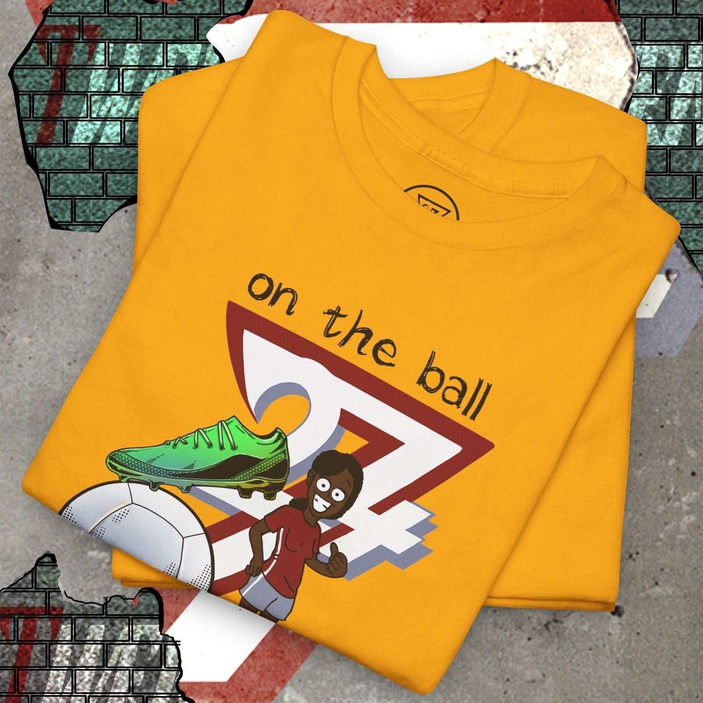 Yellow women's football boot tee with hand-drawn soccer boot and player graphic, "on the ball" text design