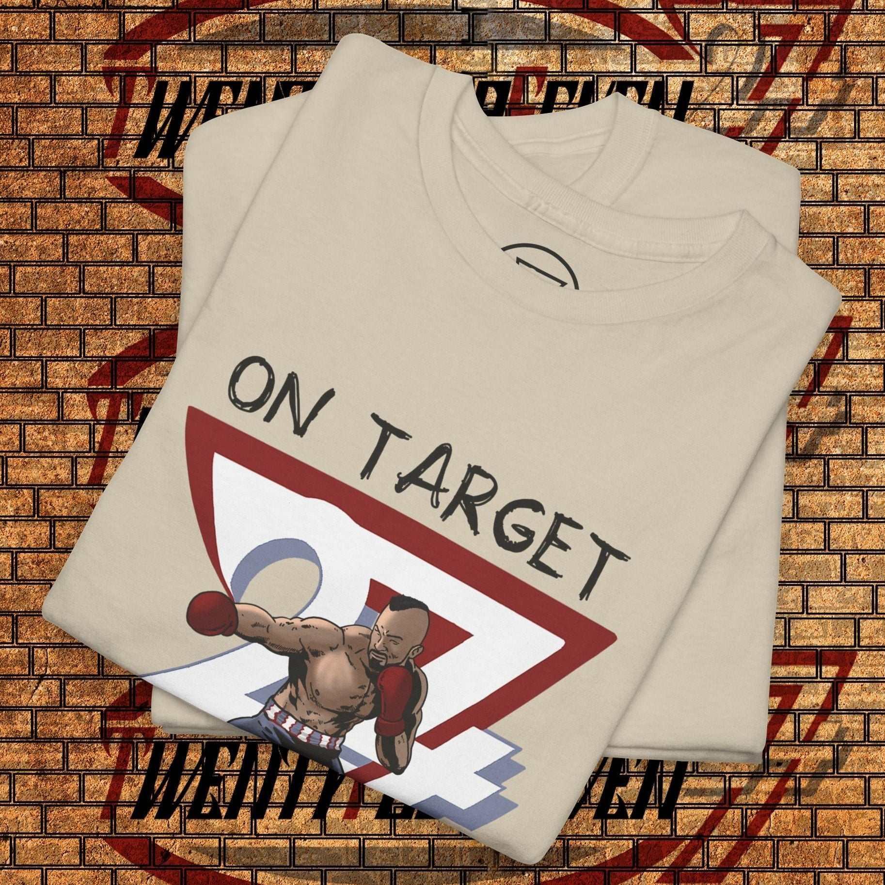beige boxing graphic shirt with hand-drawn boxer and "ON TARGET" text, folded on brick background