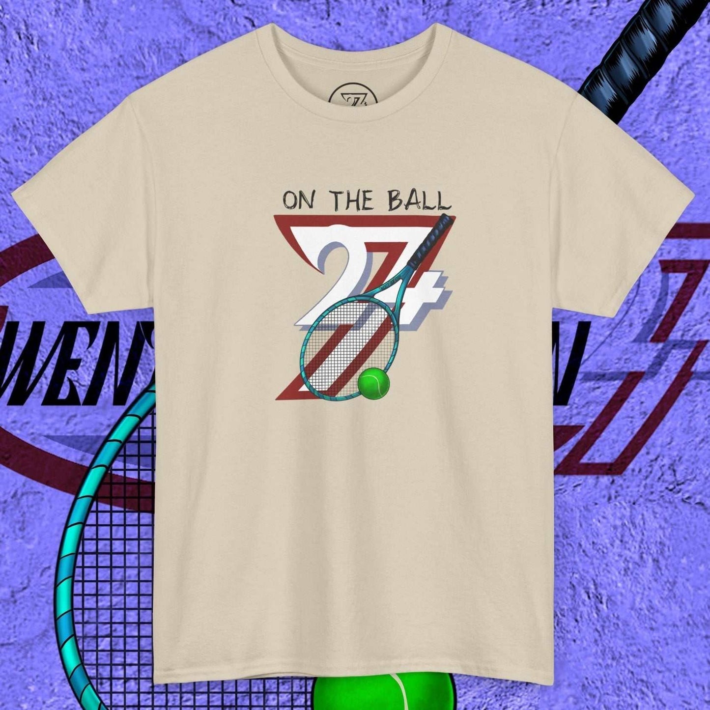 beige tennis tee with hand-drawn "On the Ball 24/7" graphic featuring tennis racquet and ball