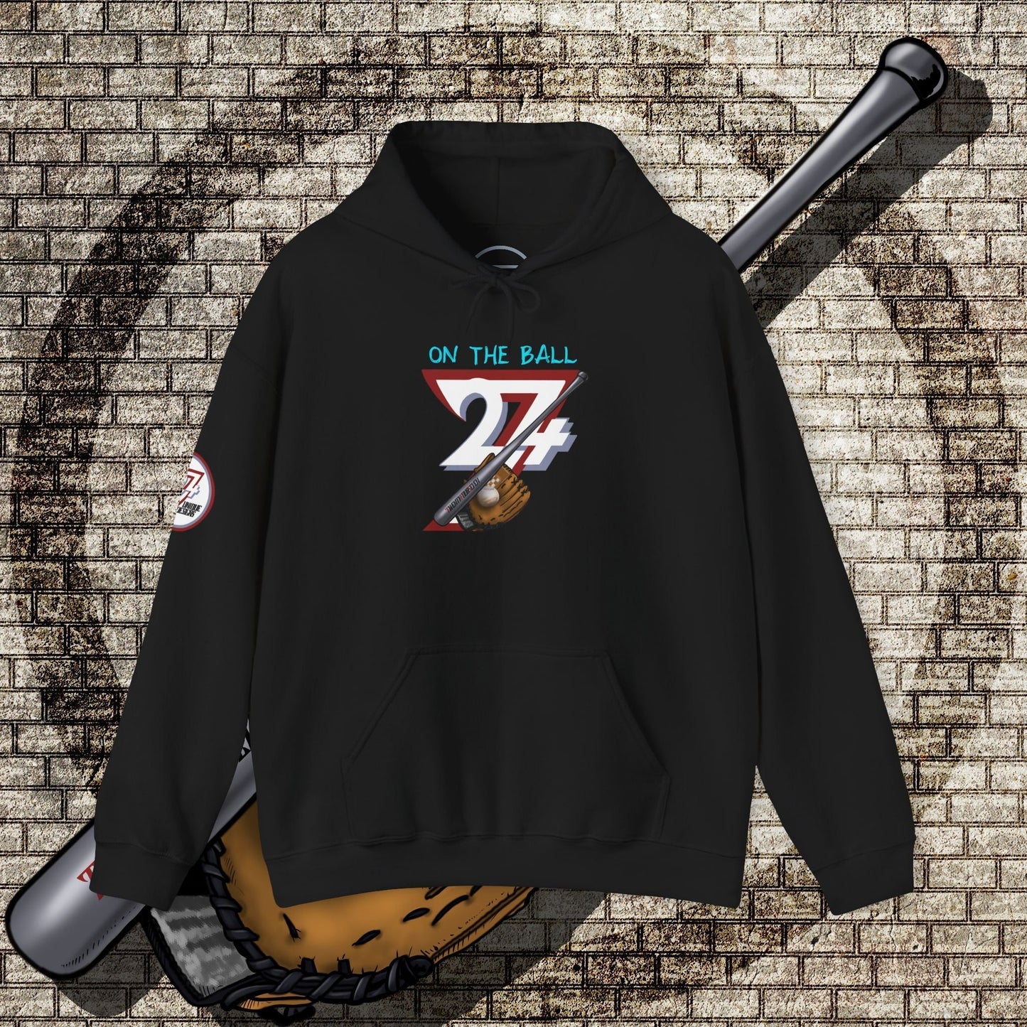 black baseball hoodie with "ON THE BALL 24/7" graphic and baseball glove design, kangaroo pouch pocket, adjustable hood, unisex outdoor sports apparel