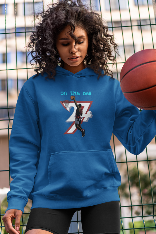 blue basketball hoodie with unique hand-drawn design, front kangaroo pocket, and adjustable drawstring hood worn by woman holding basketball outdoors