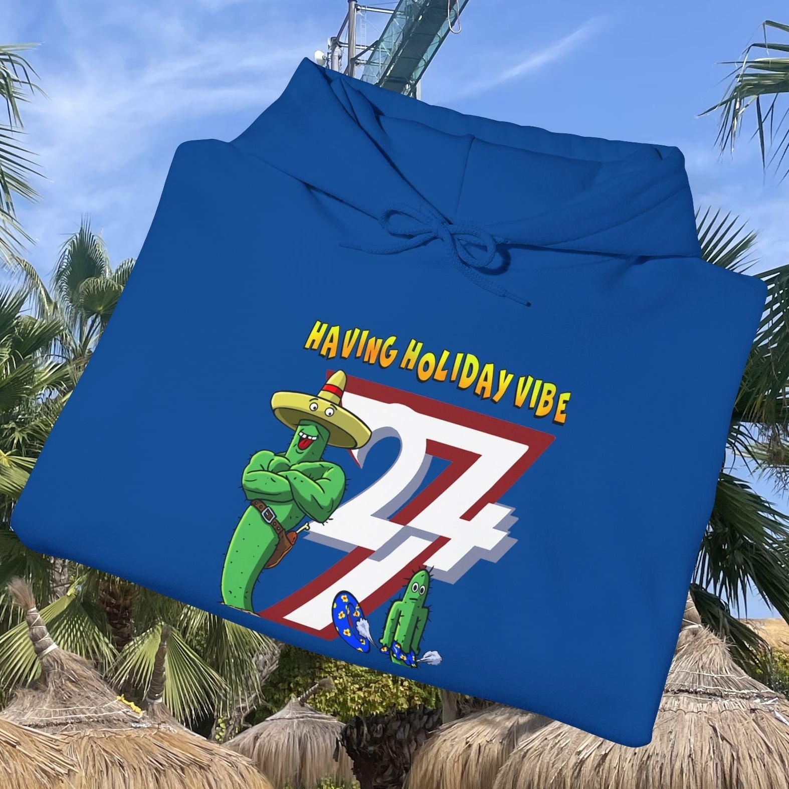blue cactus hoodie with cartoon cactus character wearing sombrero and text "Having Holiday Vibe"