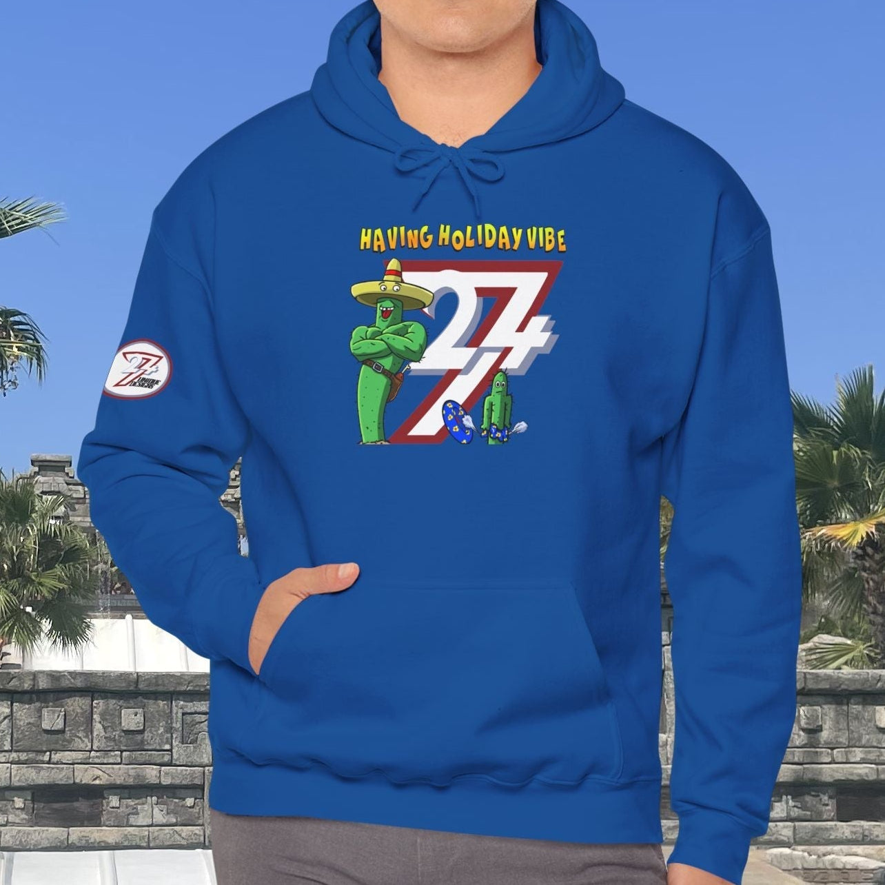 blue holiday cactus hoodie with cartoon design and kangaroo pocket worn by man outdoors