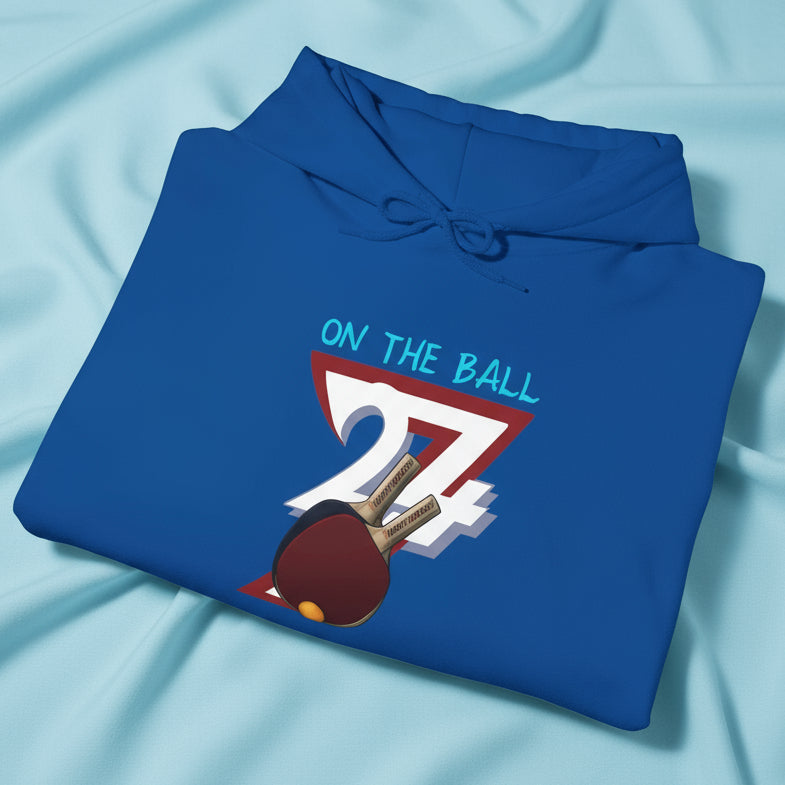 blue ping pong hoodie with hand-drawn paddle and ball design folded neatly