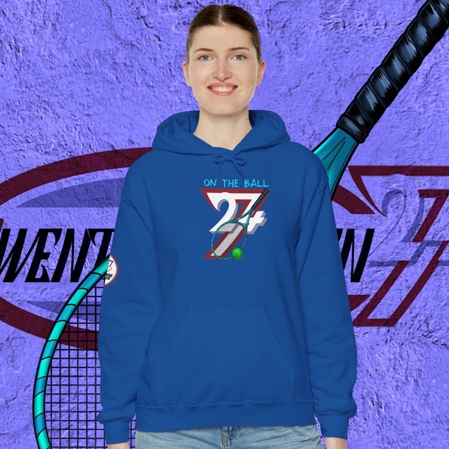 blue tennis hoodie with hand-drawn tennis gear design worn by smiling model against purple textured background