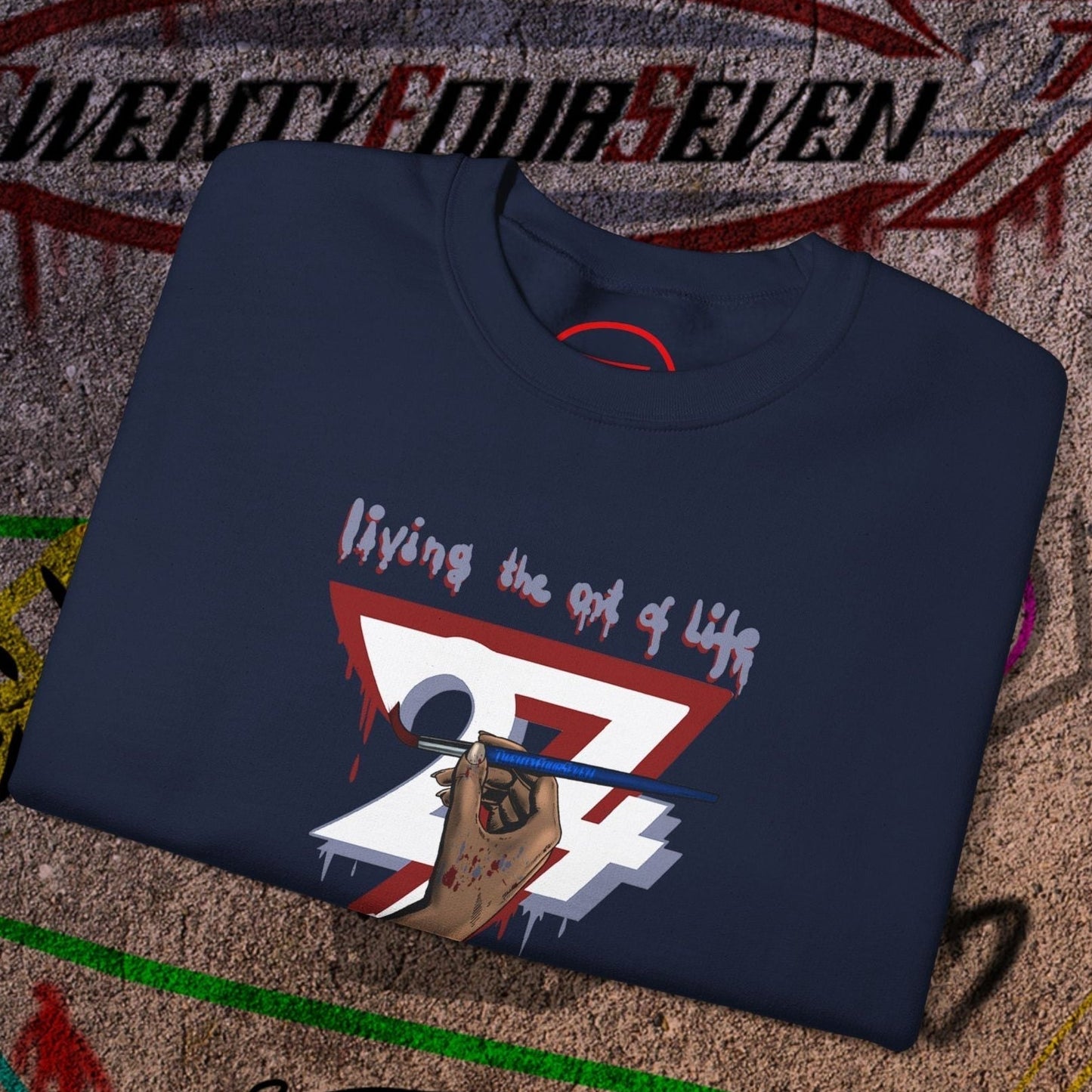 folded navy blue artist brush sweatshirt with unique hand-drawn bohemian design reading "living the art of life"