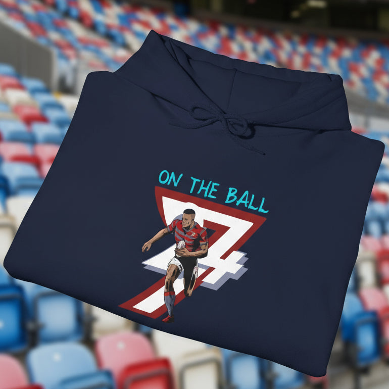 folded navy rugby hoodie with vibrant hand-drawn rugby player and "ON THE BALL" text design