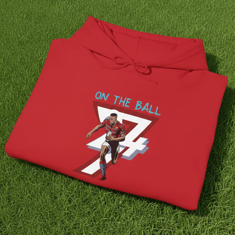 folded red rugby hoodie sweatshirt with vibrant hand-drawn rugby player and "ON THE BALL" text design