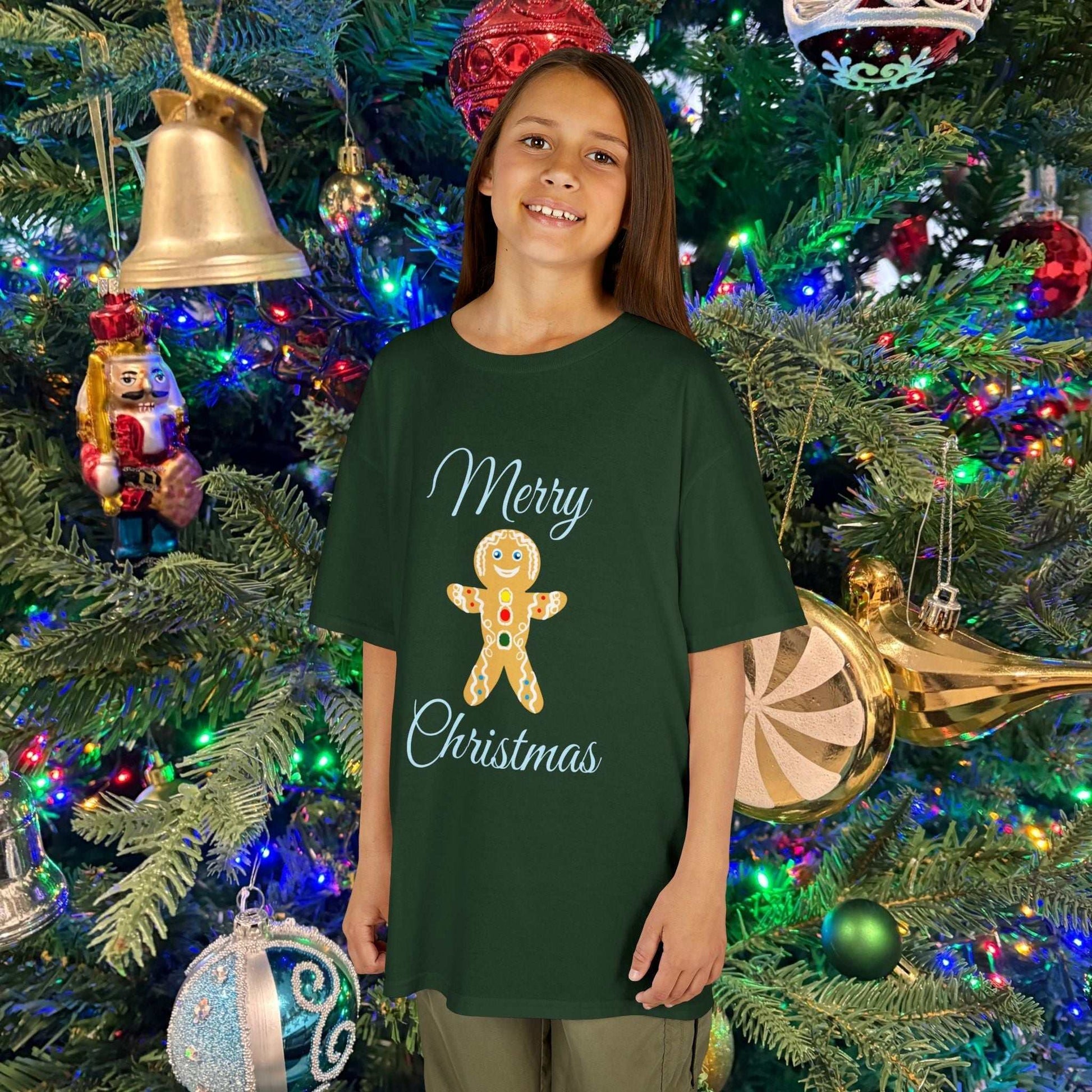 Young girl wearing the Holiday Green Gingerbread shirt, showcasing the soft fabric and bright festive color.