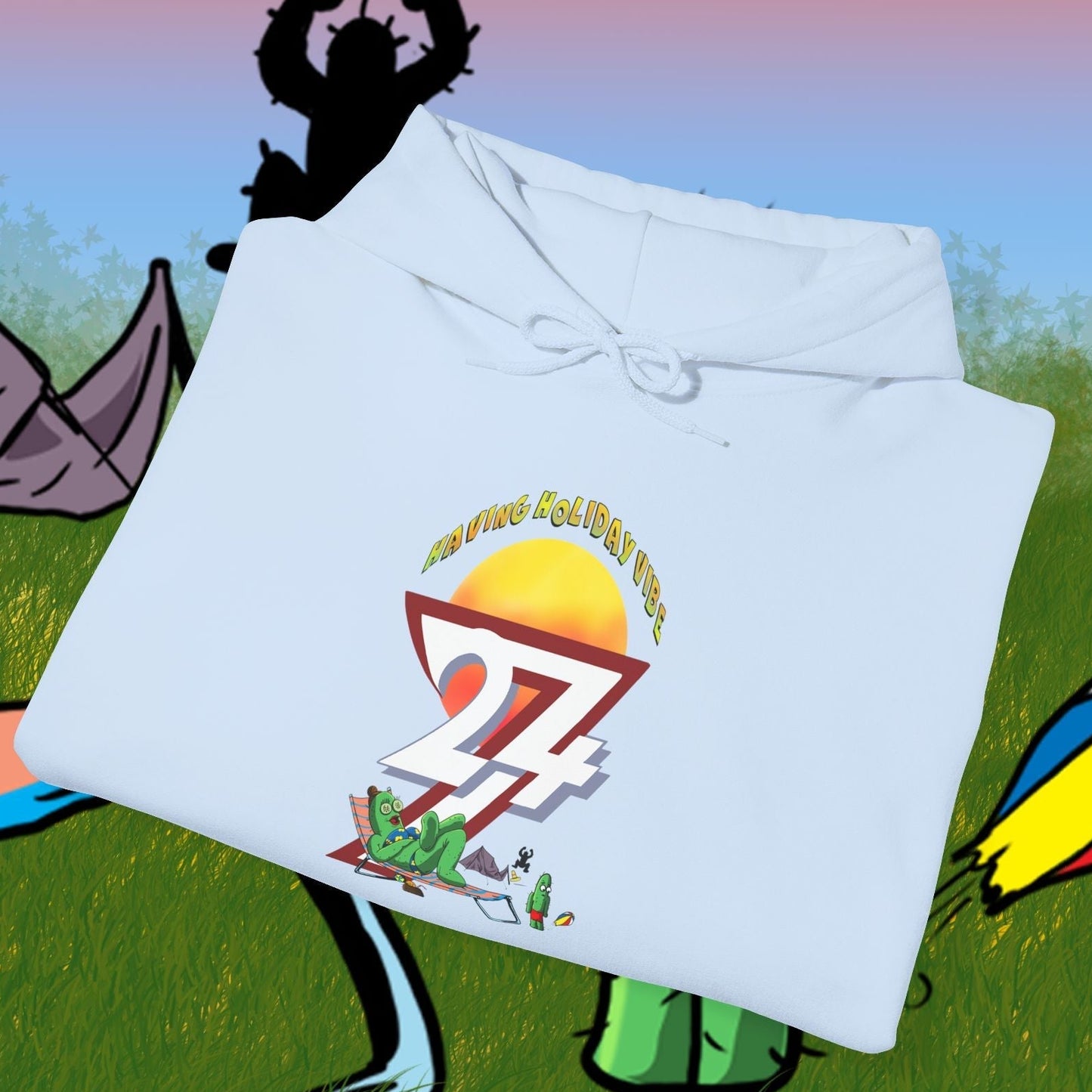 light blue cactus hoodie with cartoon character and camping design folded on outdoor background