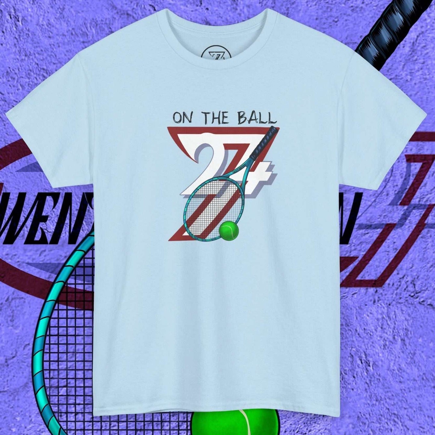 light blue tennis tee with hand-drawn "On the Ball 24/7" graphic and tennis racquet illustration