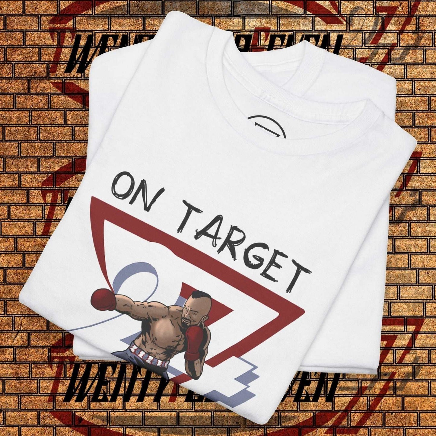 white boxing graphic shirt with hand-drawn boxer illustration and "ON TARGET" text, folded on brick wall background