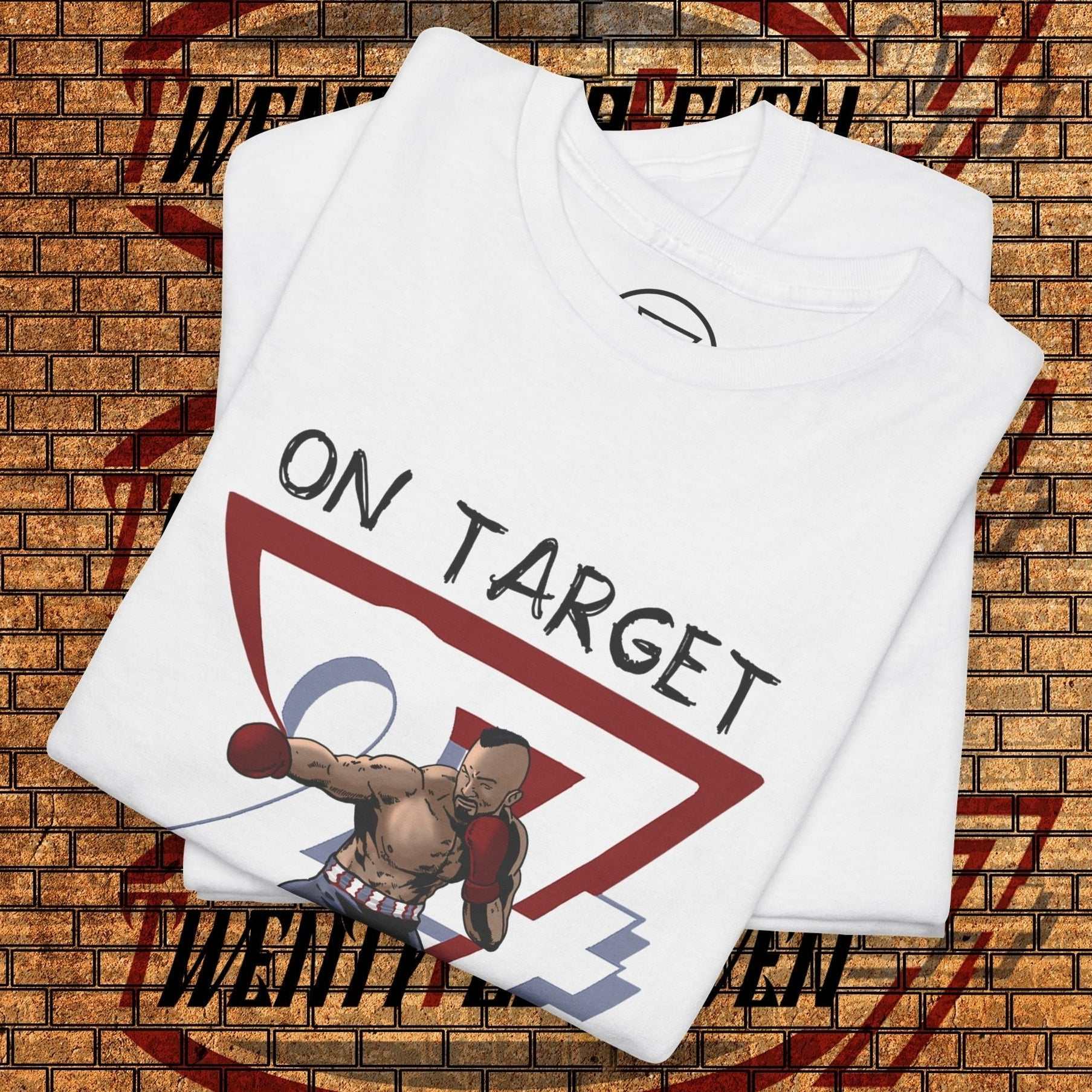 white boxing graphic shirt with hand-drawn boxer illustration and "ON TARGET" text, folded on brick wall background