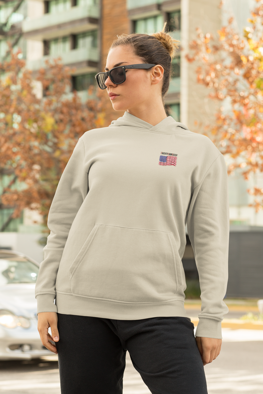 woman wearing beige American flag hoodie with small US flag logo and sunglasses outdoors