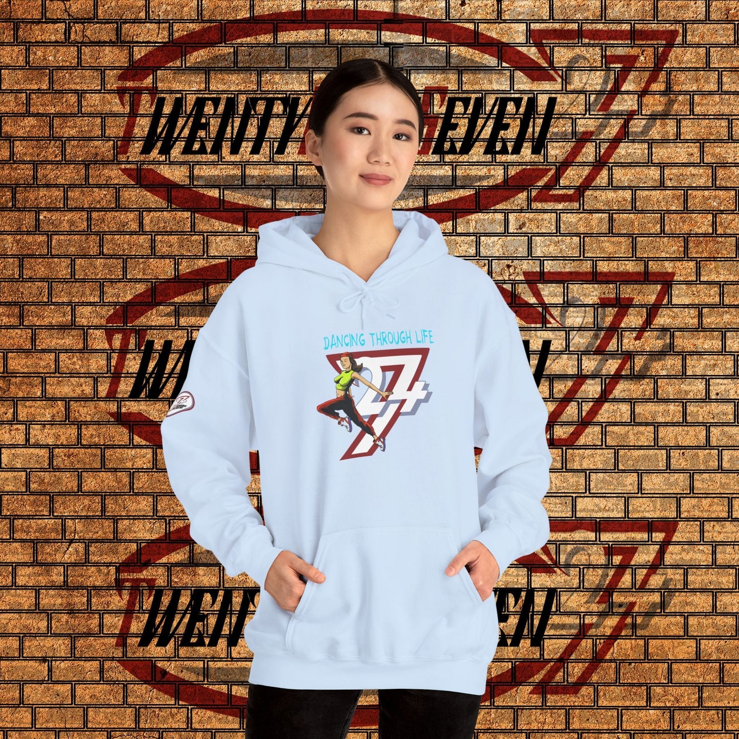 woman wearing cool urban street dance hoodie with hand-drawn illustration and kangaroo pocket against brick wall
